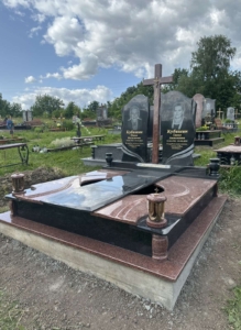 Пам'ятник на двох із натурального граніту з хрестом та гравіюванням портретів.